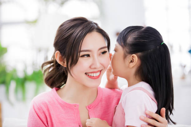 istock Daughter whisper to mom 1216925328