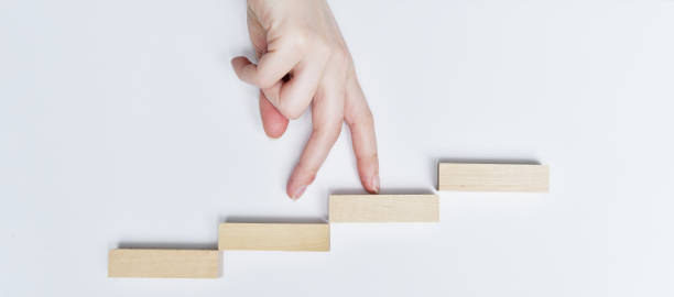 istock Way to success, Walks her fingers up the steps. 1216925484