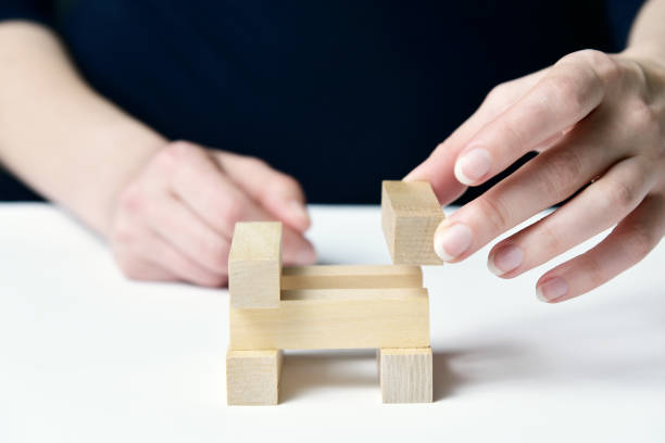istock Women's hands are building a tower 1216925504