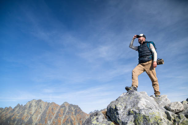 istock Mature man with backpack hiking in mountains in summer. 1216926917