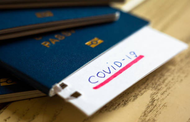 istock Passport and note with Covid-19 inscription. 1216930641