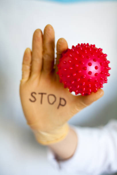 istock Stop Covid-19. Text on medical glove. 1216930773