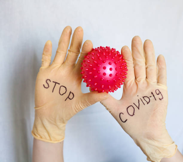 istock Stop Covid-19. Text on medical gloves. 1216930775