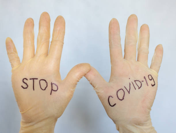 istock Stop Covid-19. Text on medical gloves. 1216930777