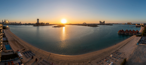 Panorama from the Palm Jumeirah in Dubai at sunset. View from the outer ring to the Palm in the middle.
