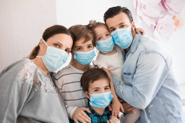 Portrait of a family at home during a Corona virus stock photo