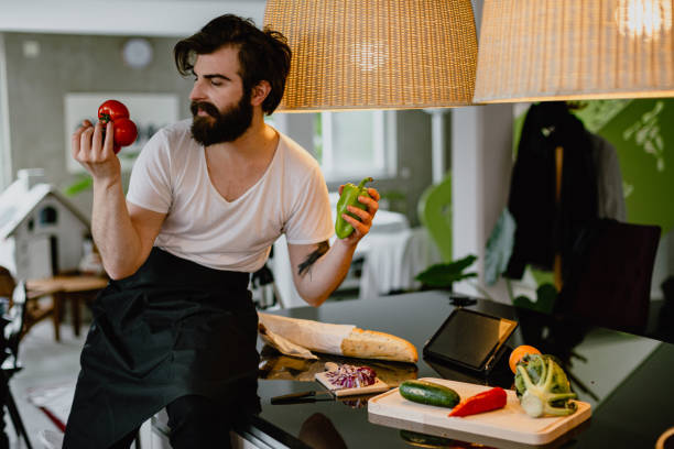 istock Man preparing healthy vegetable meal in the kitchen at home 1216934974