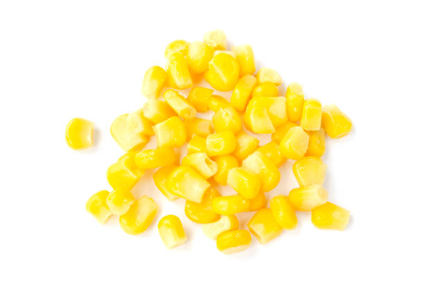 istock Canned corn isolated on a white background, top view. Yellow raw corn grains. Canned sweet corn on a white background, top view. Ripe corn grains on a white background. Layout for advertising, labels. 1216935348