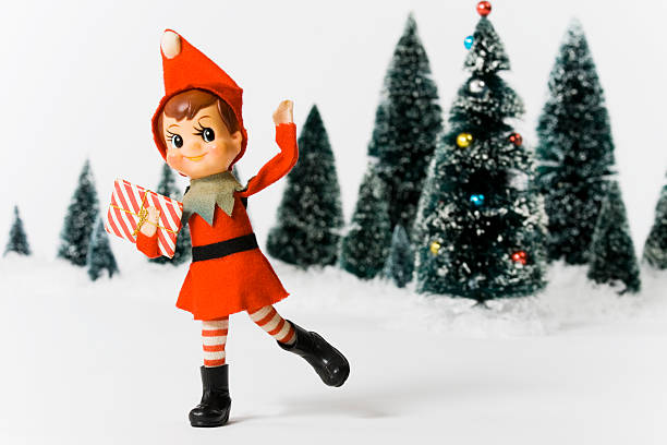 Vintage Christmas doll in front of Christmas trees Vintage pixie elf Christmas tree ornament.  Made in Japan, circa 1950's. elf stock pictures, royalty-free photos & images