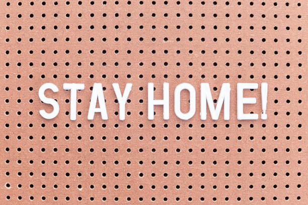 istock Words Stay home made from white letters on brown pegboard, self-isolation, horizontal 1216936509