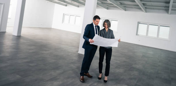 istock Business People Discussing Blueprint 1216938943