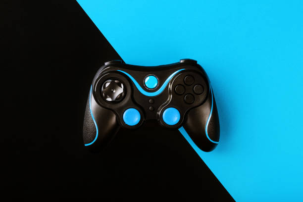 istock Black gamepad on black and blue background, by . Game concept. Device to control and control the game. 1216943683