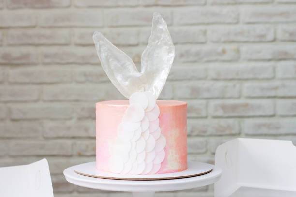 Mermaid theme candy bar with cake, cupcakes, macaroons and biscuits. Sea shell shaped macaroons with pearls.