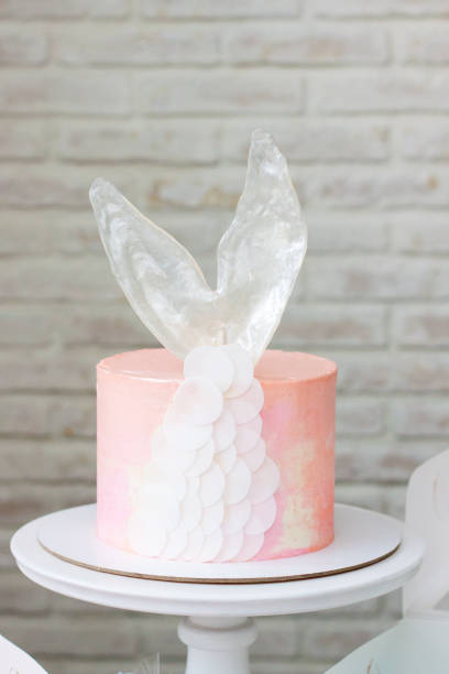 istock Mermaid theme candy bar with cake, cupcakes, macaroons and biscuits. Sea shell shaped macaroons with pearls. 1216943885