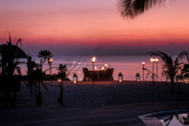 istock Romantic Maldivian Sunset Beach Dinner with candlelight 1216946122