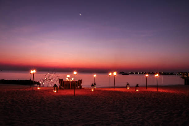 istock Romantic Maldivian Sunset Beach Dinner with candlelight 1216946134
