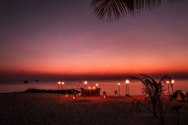 istock Romantic Maldivian Sunset Beach Dinner with candlelight 1216946145