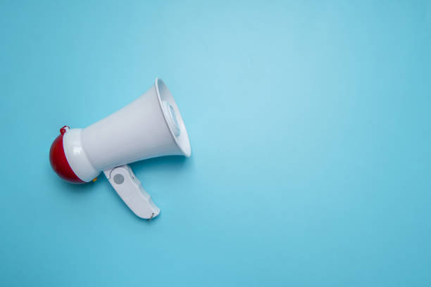 istock Megaphone announcement on blue background with copy space 1216948499