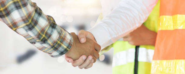istock Close up engineer shaking hand with building contractor in construction site , successful negotiate of manager and industrial agreement cooperation concept 1216948529