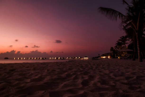 istock maldives sunset by the beach 1216950622
