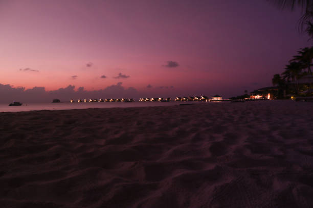 istock maldives sunset by the beach 1216950711
