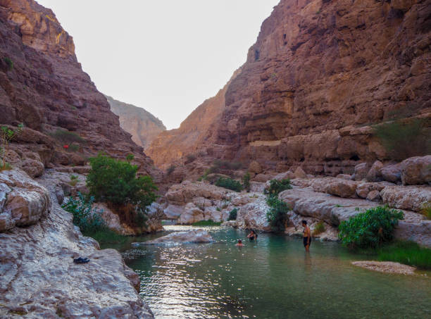 Natural Swimming Pool at Wadi Shab, Oman In November 2019, tourists were swimming in the Natural Swimming Pools at Wadi Shab, Oman wadi shab stock pictures, royalty-free photos & images