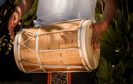 Maldivian Bodu Beru Drummers dressed in sarongs playing at the Beach. The Bodu Beru Drum is a traditional drum played at ceremonies, celebrations and festivals in Maldives