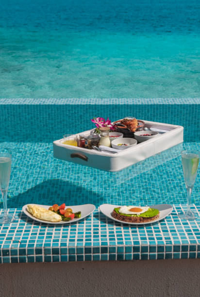 istock Luxurious Floating Breakfast tray in Swimming Pool by the sea 1216953909