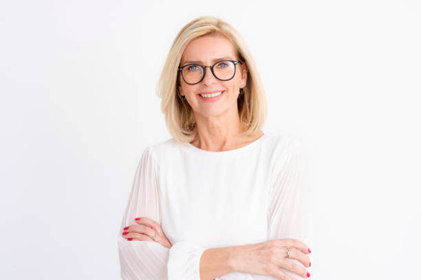 istock Attractive senior woman studio portrait while looking at camera and smiling 1216954105