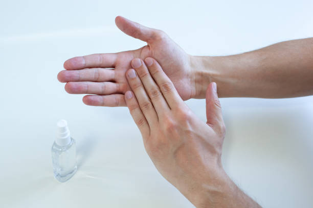 istock Man hand using wash hand sanitizer gel pump dispenser for protection coronavirus, germ and bacteria, health care concept, 8 step hand wash prevention covid19. Closeup hand applies a disinfectant spray 1216954121