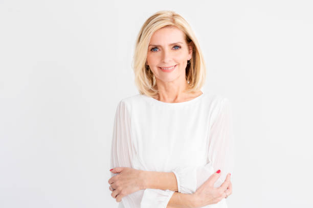 istock Attractive senior woman studio portrait while looking at camera and smiling 1216954143