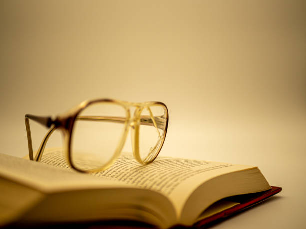 istock cracked eyeglasses resting on a open book vintage look photo 1216954814