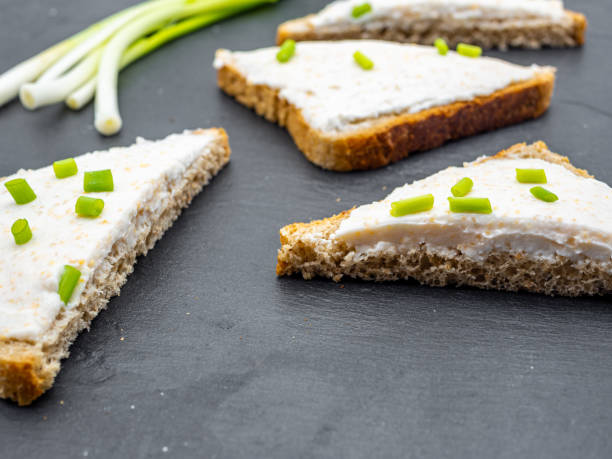 istock fish roe paste spread on bread slices and green onion on slate breakfast snack concept 1216954838