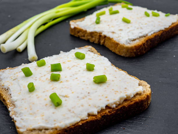 istock fish roe paste spread on bread slices and green onion on slate breakfast snack concept 1216954847