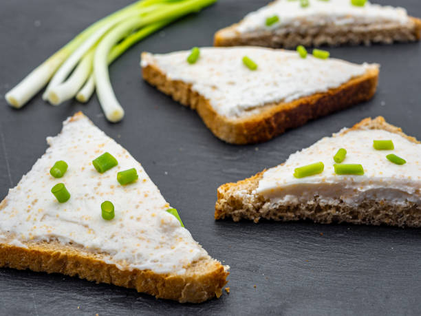istock fish roe paste spread on bread slices and green onion on slate breakfast snack concept 1216954901