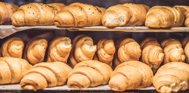 istock French Croissants on a showcase in a bakery shop 1216954903