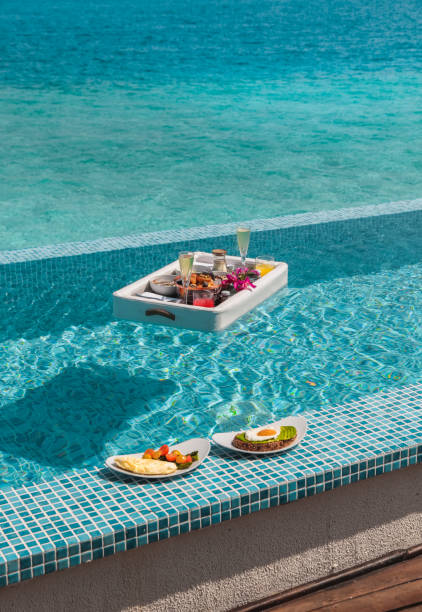 istock Luxurious Floating Breakfast tray in Swimming Pool by the sea 1216955317