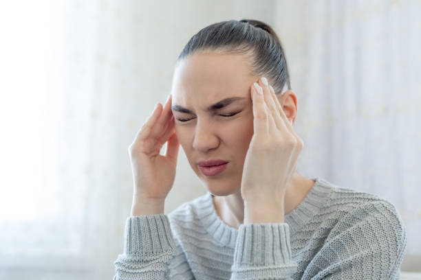 istock Young woman with a headache 1216956903