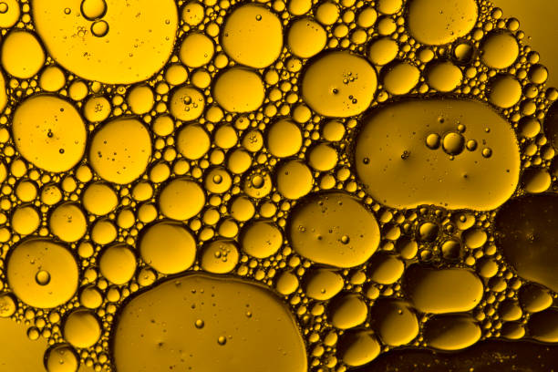 istock Abstract Yellow water bubbles background. Macro shot . Oil bubbles close up 1216958119