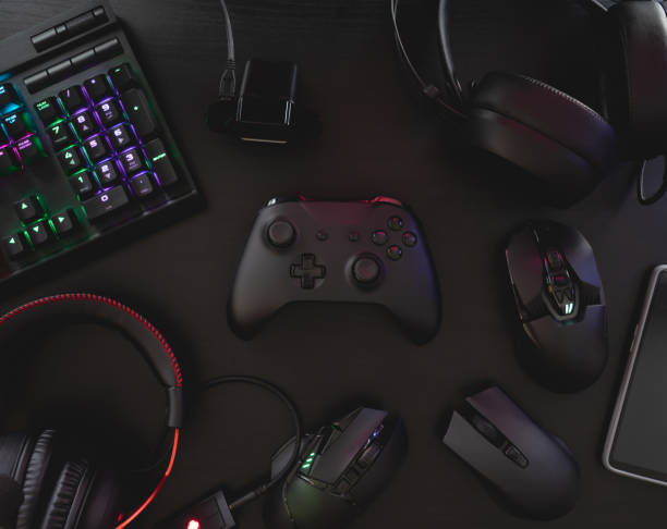 istock gamer work space concept, top view a gaming gear, mouse, keyboard, joystick, headset, mobile joystick, in ear headphone and mouse pad on black table background. 1216959484