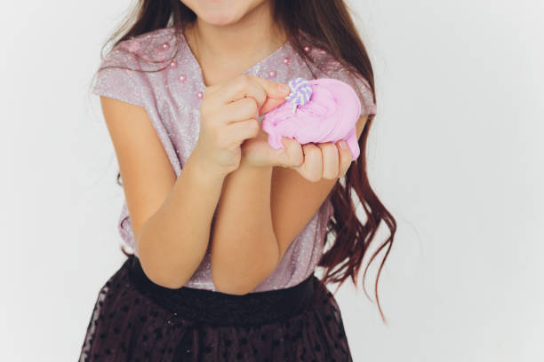 istock Young girl playing with slime. Isolated on white background. 1216962701
