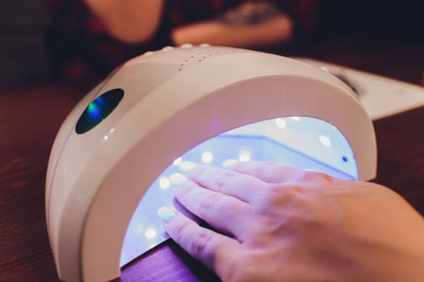 istock Beautiful nails below UV lamp 1216962805