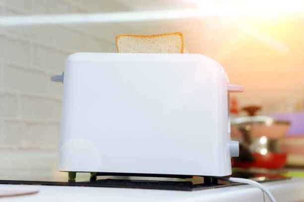 istock Roasted toast bread from white modern toaster machine in the kitchen 1216964541