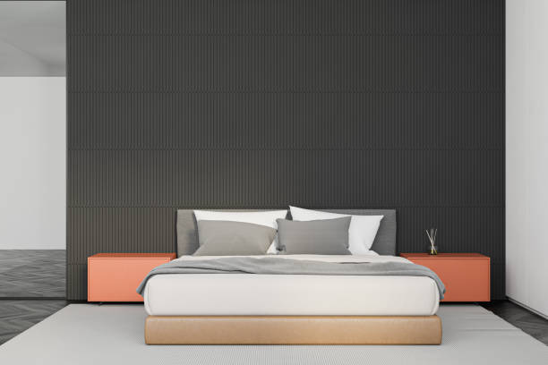 istock Gray master bedroom interior with orange tables 1216964794
