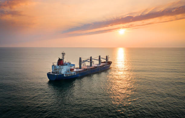 istock Cargo ship in the ocean on the sunrise. 1216965046