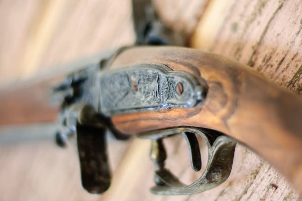 istock Old, rusty gun on the wall. Weapons on the wall. 1216966434