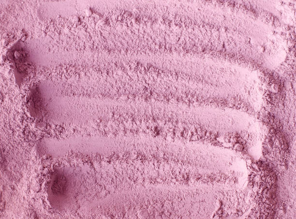 istock Pale pink cosmetic clay powder (rhassoul, facial mask, face cream, body wrap) texture close up, selective focus. Abstract background with brush strokes. 1216968145