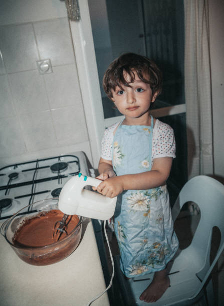 istock Little boy using an electric mixer for baking cake 1216968172