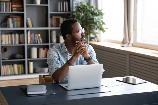 istock Distracted from study job young biracial man lost in thoughts. 1216968861