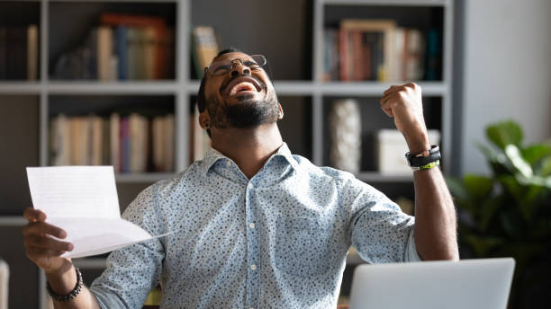 istock Overjoyed young mixed race man celebrating unbelievable triumph. 1216968899